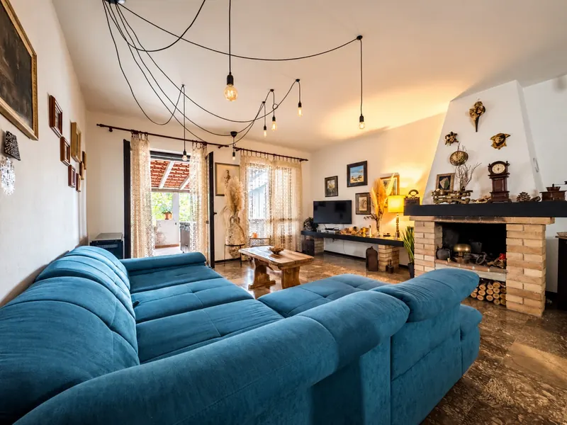 Living area with blue sofa and fireplace