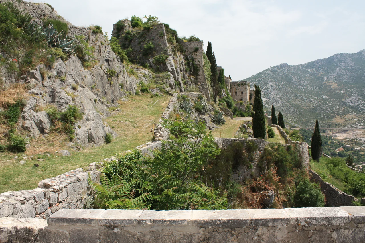 Stone walls and rocky hillside at Klis Fortress in Klis, Croatia