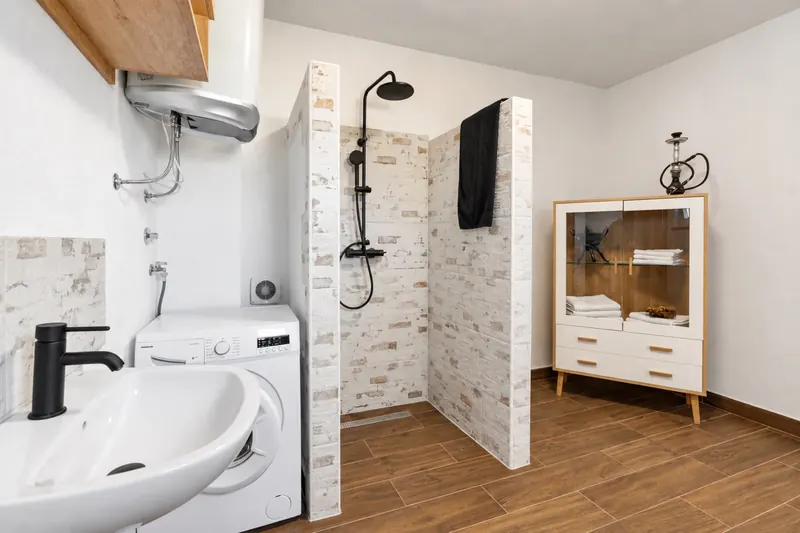 Shower room with walk-in rainfall shower, washbasin and washing machine
